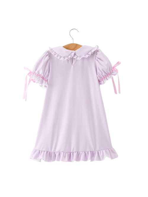 Lavender dress with ruffled details on a white background